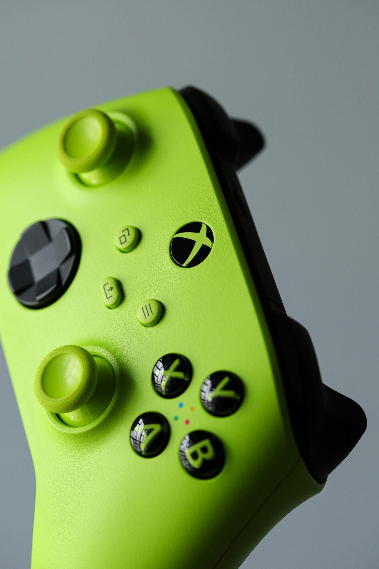 A close up of a green video game controller